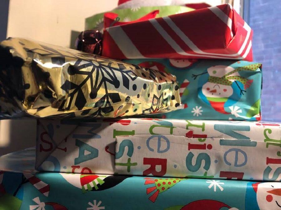 Holiday gifts are stacked up, ready to be given. Gifts like these were distributed to families in need by the Adopt-a-Family program.