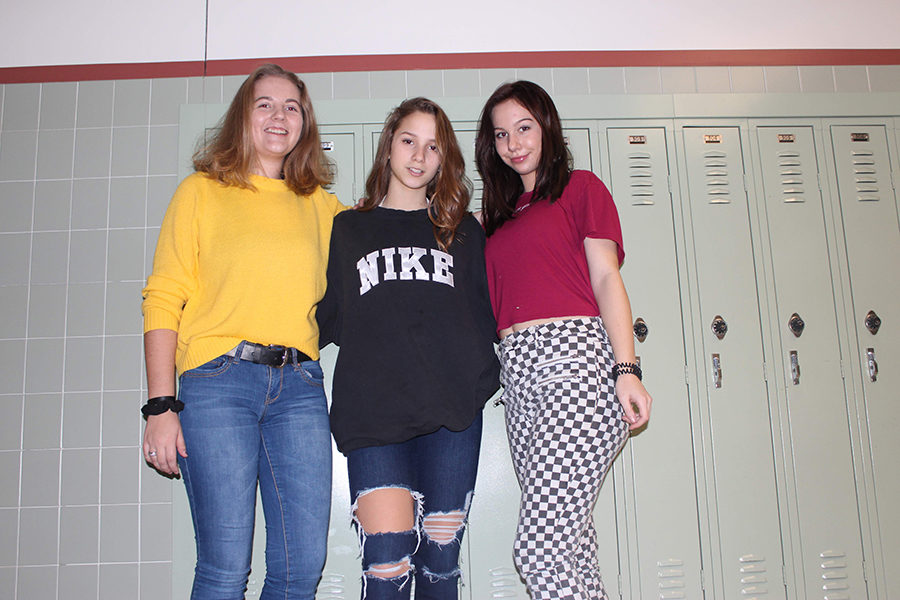 Sarah Gally, Olivia Grippin and Isabelle Whitten (Pictured left to right), pose wearing some old school vans and scrunchies.  
