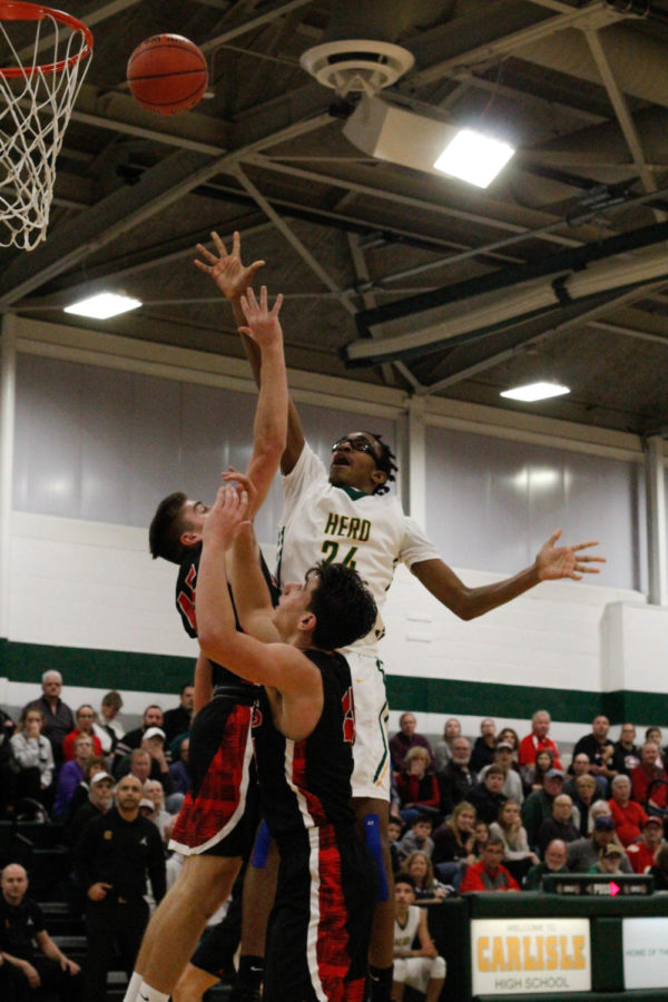 Jump In: #24 Varsity James Barlow jumps to great heights to push that ball through the net. 