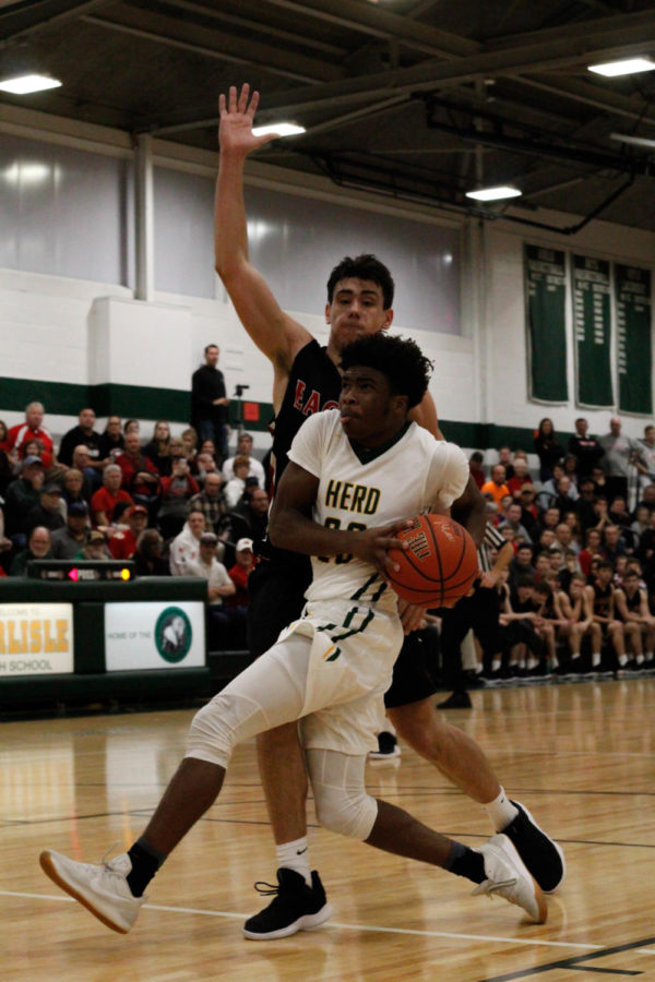 Dodging the Block: #20 Varsity Kurtis Ravenel dodges the block from CV about to score some points. 