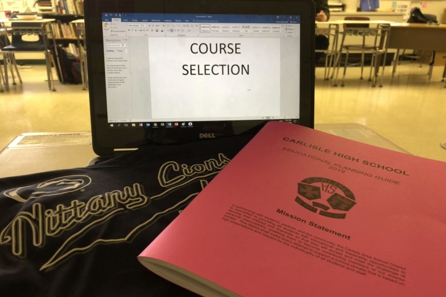 A course selection booklet sits with a Penn State pennant. Penn State classes will no longer be offered at Carlisle High School after this school year.