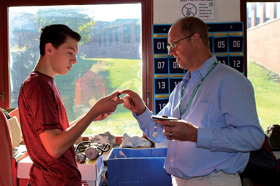 Freshman Jacob Murphy and geo-environmental teacher William Bechtel work together to find the right parts for Murphys BattleBot during a club period. 