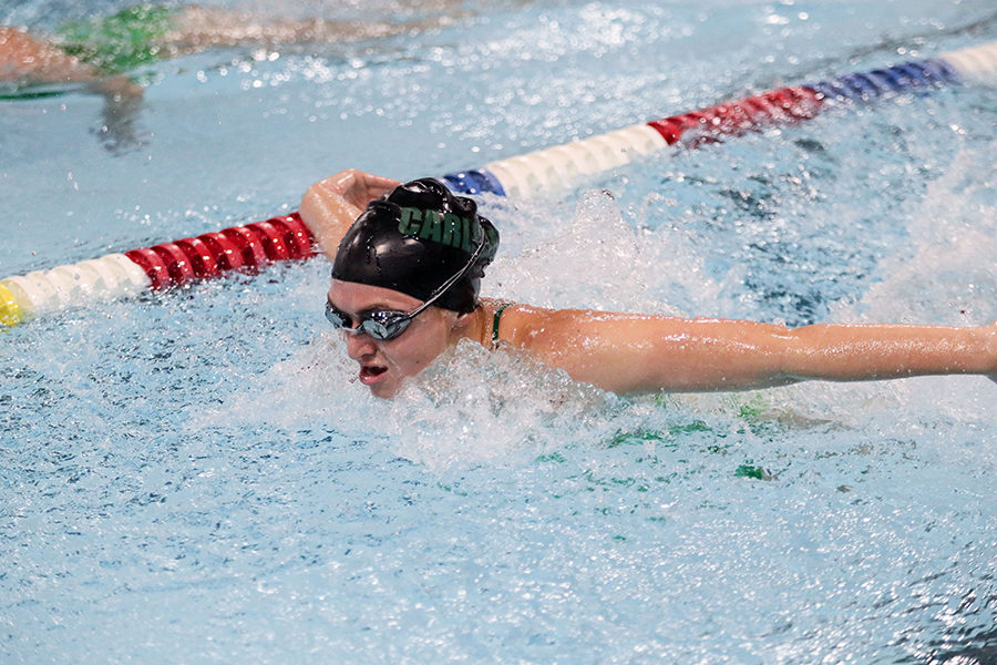 Varsity athlete Sierra Young swims butterfly during a swim meet.  She was a captain this year and will look to return as captain next season.