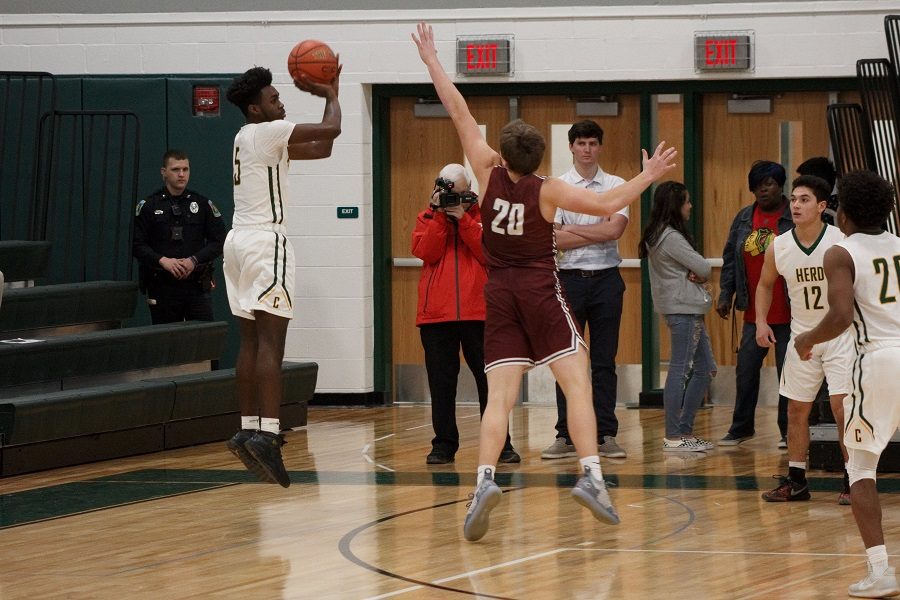 Senior Dayne Grays shoots a three-pointer during the first quarter of the game vs State College.  Grays scored 7 points in the 54-39 upset win on senior night.