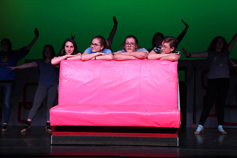 The Pink Ladies played by Talia Clash, Kelsey Sheffe and Bri Murrary, are joined by Chloe Kot (playing Patty Simcox) on stage as the ensemble dances behind them. Participating in the musical allows students to experience the process of staging a musical.