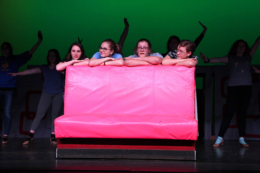 "The Pink Ladies" played by Talia Clash, Kelsey Sheffe and Bri Murrary, are joined by Chloe Kot (playing Patty Simcox) on stage as the ensemble dances behind them. Participating in the musical allows students to experience the process of staging a musical.