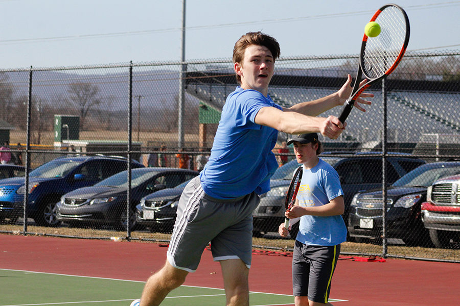 Varsity player Jessie Beck hits a backhand volley back over the net during a practice drill. Beck is a sophomore and is the number 1 singles on the team. 