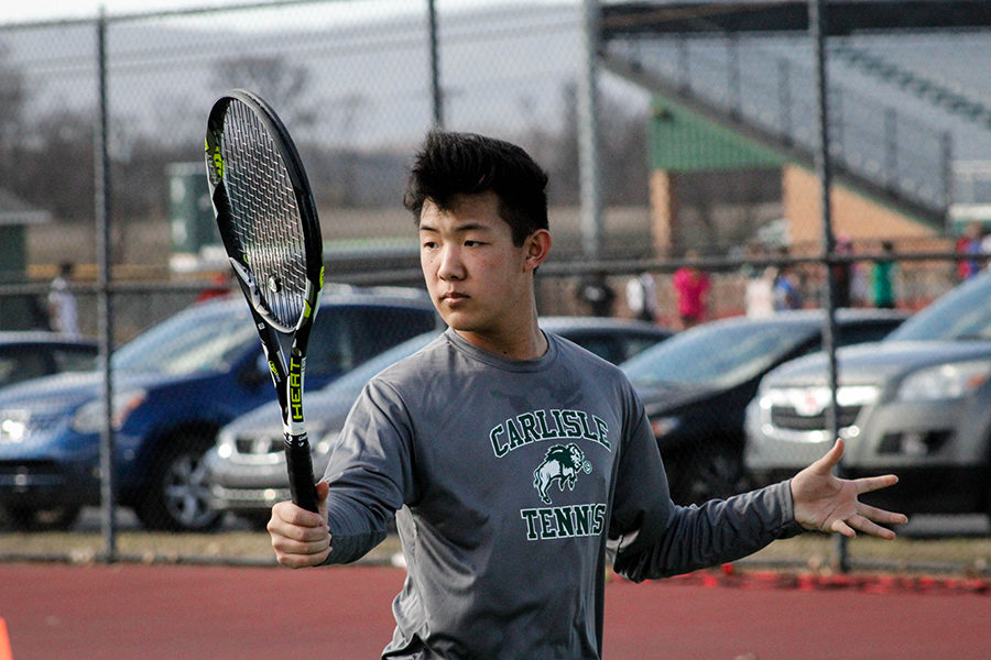 Varsity player Ryan Jin follows through on his volley. His teammates practiced this volley drill every day at practice. 