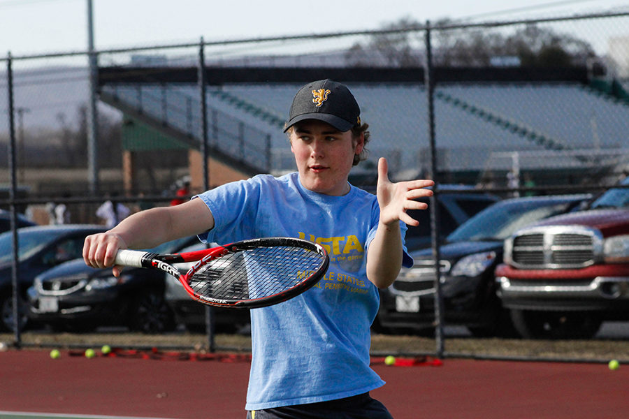 Varsity player Sean Bergsten follows through on his volley during a practice drill. This is his second year on the boys tennis team and is on the 2nd doubles team with James Kem. 