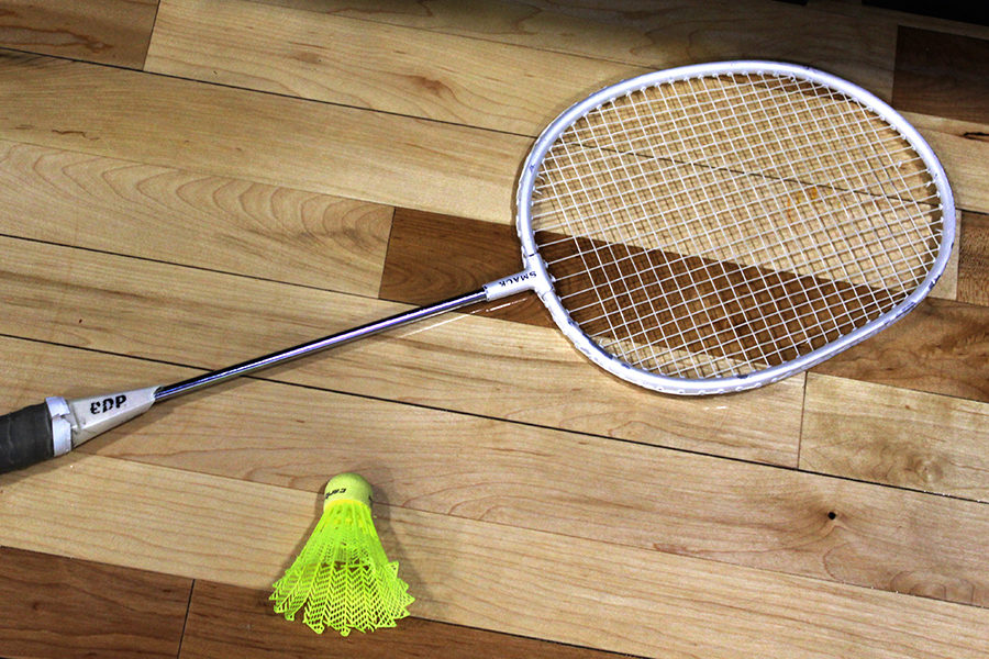 A+badminton+racket+and+birdie+layed+out+on+the+floor+of+the+gym.++Badminton+is+one+of+the+favorite+units+of+the+year.++
