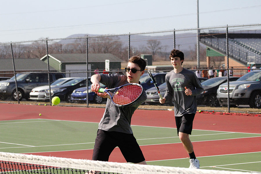 Varsity players Robert Wellmon (front) and James Kem (back) run through a volley drill during tennis practice. The team was practicing fresh off their win against State College. 