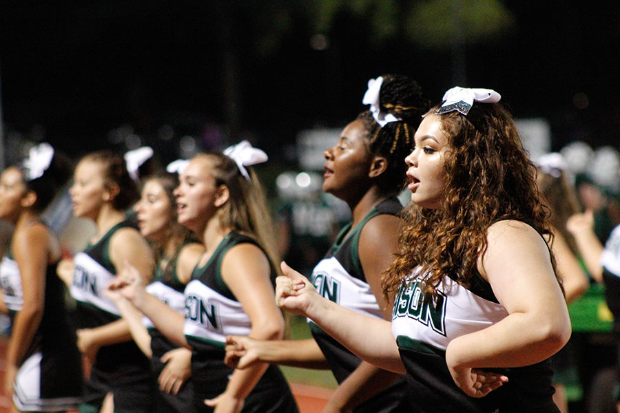 Varsity cheerleaders Mariana Machin (right) and Daija Berry join their fellow team members to perform a routine for Carlisles football team during the 2018 fall season. The varsity cheerleaders also cheer for the varsity boys basketball team. 