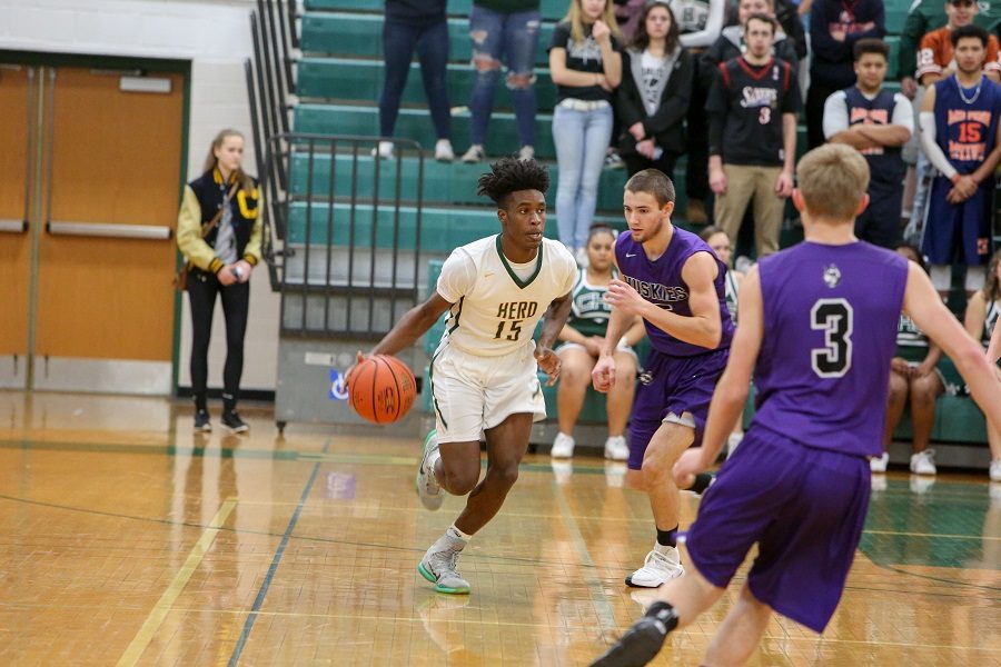 Deshawn Millington dribbles down the court while playing in a game his senior year.  Millington is one of CHS athletes that went on to play at the collegiate level.