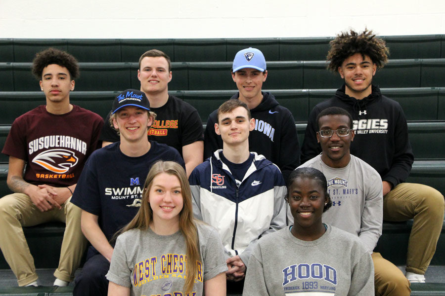 9 seniors celebrated signing with the respective colleges on April 17. Front row: Jessica Petrunak, Marlise Newson. Middle row: Caleb Padgett, Seth Collins-Bloomquist, Nicolas Nunnally. Back row: Howie Rankine, Dylan White,  William Mosinski, Jaden Motter