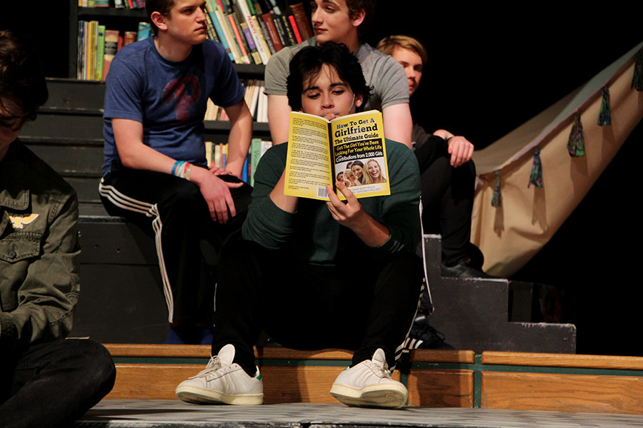 Brady Chilson, playing Berowne, begins spring break with a book. His fellow soccer players have promised to focus on education during their break. 