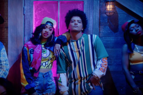 Cardi B and Bruno Mars pose in the video for their release Finesse.  The two recently collaborated again on another song, Please Me.