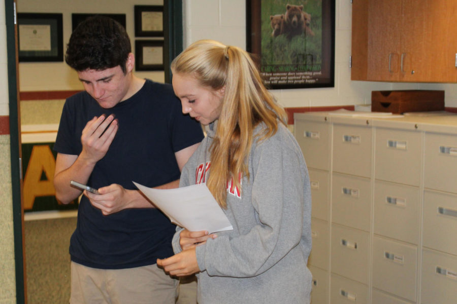 James Echevarria and Olivia Renault read the announcements from a paper provided each morning.  The announcements occur every morning and on Fridays there is a joke of the week.   