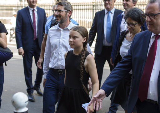 Swedish climate activist Greta Thunberg, centre, arrives for a meeting in the French National Assembly, in Paris, France, Tuesdays, July 23, 2019. (AP Photo/Rafael Yaghobzadeh )