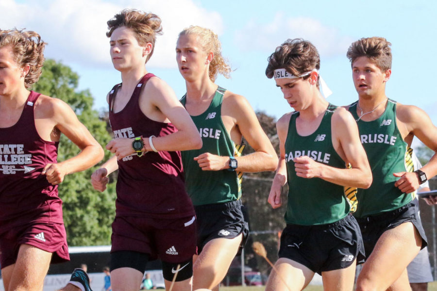 Senior Casey Padgett runs in amongst State College and Carlisle runner during a meet.  Padgett has been a key leader for the team, following in the footsteps of his siblings who also ran for Carlisle XC.  