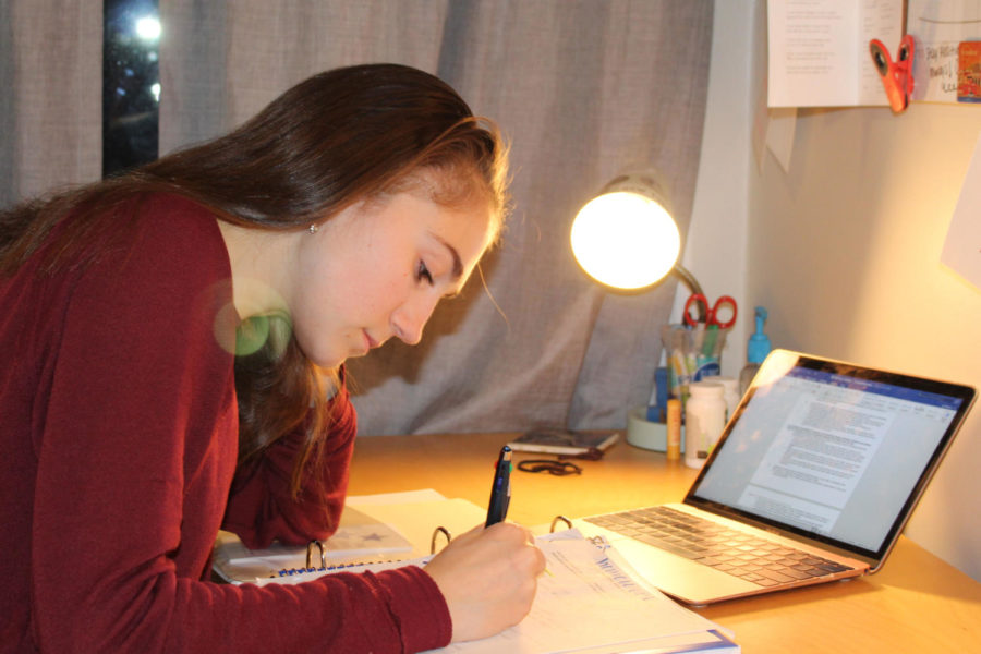 Juniors, like Lulu Herman (seen here) can find themselves up late into the night, working on homework and studying for tests.  Junior year is often seen as the most crucial year due to it being the most recent year seen by colleges during the application process.