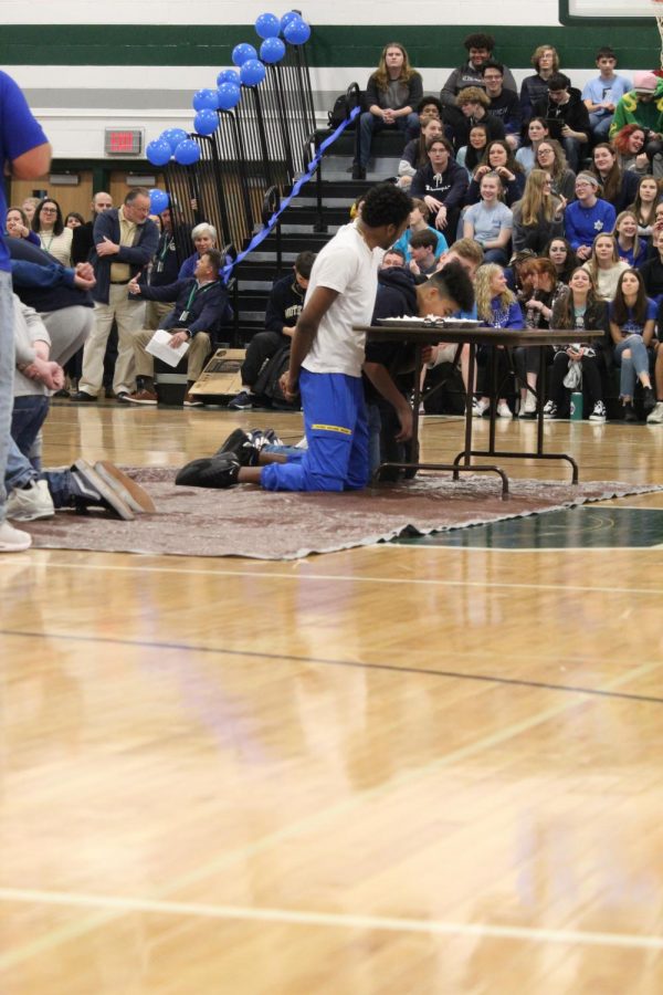 Senior James Barlow waits, with arms behind his back, to begin the pie eating contest.  Barlow was crowned as the 2020 Winterball king.