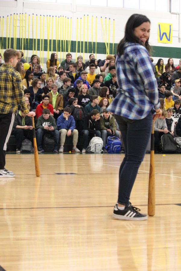 Trinity Johnson, Carter Smith, and Tim Mattaboni wait to spin themselves silly. This obstacle you had to spin around in circles with your head on the bat.