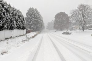 Layers of snow and ice cover a local road. When inclement weather makes travel to and from school impossible, is it better to use a Flexible Instruction Day that day or a snow make-up day later in the year? Our two Editors-in-Chief debate this very question.