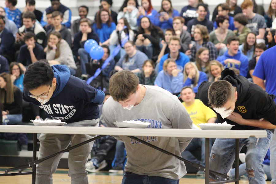 Winter Ball court members Michael MJ Julias, Eric Hoover, and Marty MJ Brown, all seniors, participate in a pie eating contest.  This was one of the highlights of the Winter Ball pep rally.  