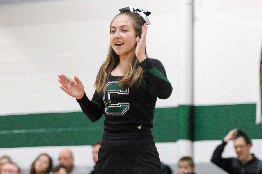 Senior+Jenna+Trolinger+cheers+on+the+crowd+at+a+recent+boys+basketball+game.+Trolinger+is+one+of+the+teams+flyers%2C+which+means+she+is+hoisted+into+the+air+to+do+stunts.