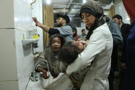 Dr. Amani Ballour holds a sick child in her arms in this still from The Cave. The Cave, which focuses on Dr. Ballour's work in an underground Syrian hospital, will premiere in Carlisle March 26.