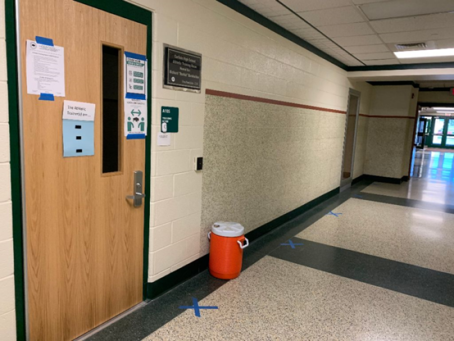 SAFETY FIRST: The athletic training room uses blue tape to mark social distancing for students in
need of their help. This year, extra safety precautions are being taken in sports which not only affects games/meets and spectators, but also how athletic training is approached.