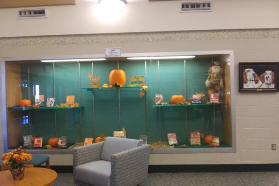 FEELING FESTIVE: In efforts to get in the fall spirit, the school library has set up their annual display. This display is filled with beautiful pumpkins, colorful leaves, and a variety of books that fit the theme of what happens during the fall season.