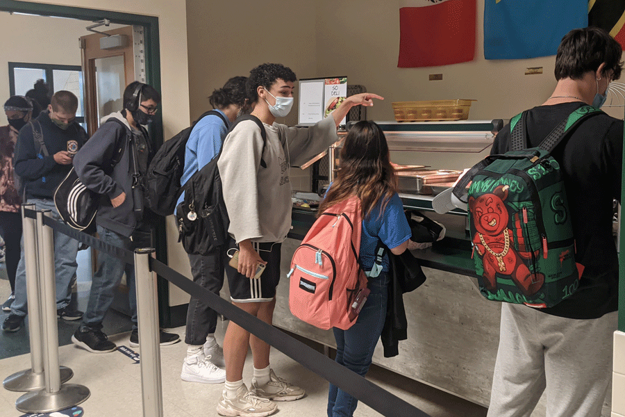 Senior Tyler Sandoval checks out the lunch offering in the McGowan cafeteria.  This year, students have limited options when buying due to Covid restrictions; however, until December, students can get the basic meal for free, thanks to a USDA regulation.