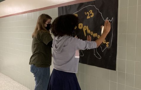 AMBITION WITH A MISSION: Both Ruby Frazier (left) and Maya Reichenbach belong to the Sophomore Class Council, for the class of 2023, and are setting up for Homecoming Week. As the hallways are lined with banners and school pride, Frazier, Reichenbach, and many of their peers are hard at work ensuring there is school pride to admire around every corner.