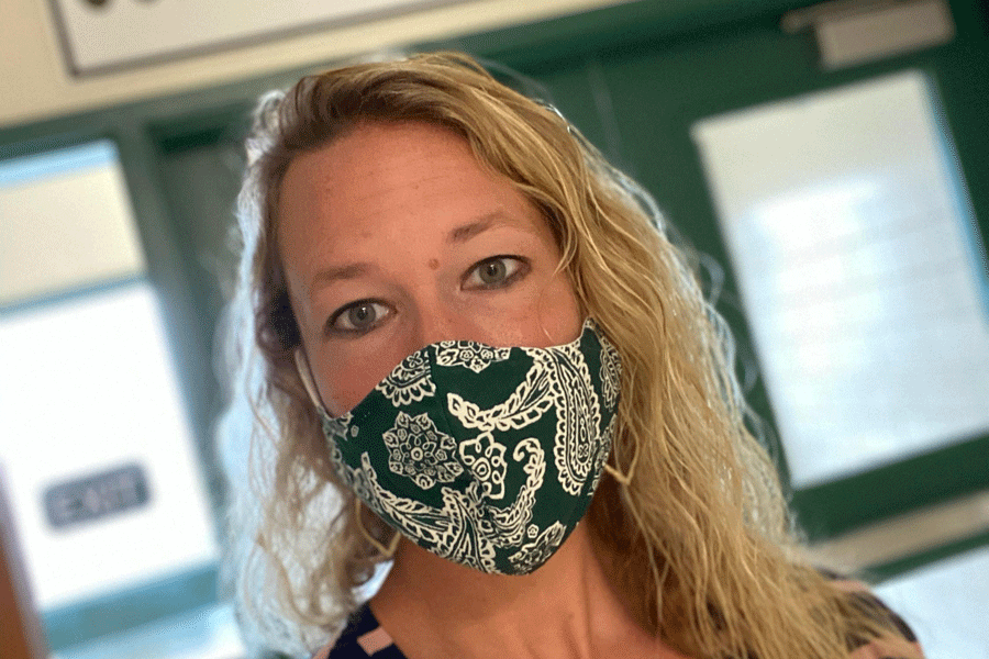 Senior English teacher Michelle Disbrow shows her C-Luv with a green and white paisley mask.