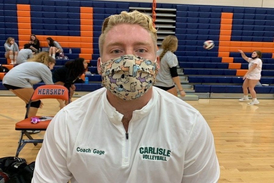 Girls volleyball coach Gage Boisvert shows off his love of dogs with his mask at practice. 