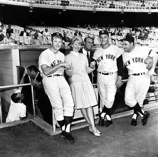 Actress Doris Day and actor Cary Grant, standing in the dugout, pose with New York Yankees players, from left, Mickey Mantle, Roger Maris and Yogi Berra before the Yankees-Dodgers game in Los Angeles, Ca., July 12, 1962.  The players appeared in the movie A Touch of Mink with Day and Grant.  (AP Photo/Ed Widdis)