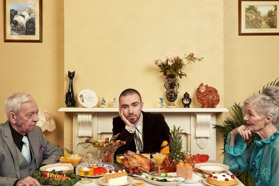 ONE BIG PLATE: The album cover for Bad Contestant shows Maltese looking very bored as he sits between a fighting older couple. 