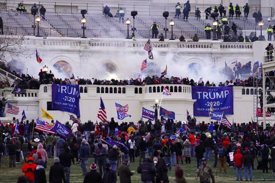 FILE - In this Wednesday, Jan. 6, 2021, file photo, violent protesters, loyal to President Donald Trump, storm the Capitol, in Washington. Federal prosecutors say a retired Air Force officer who was part of the mob that stormed the U.S. Capitol was arrested Sunday, Jan. 10, 2021, in Texas. (AP Photo/John Minchillo, File)