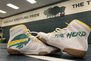 Carlisle High School inspired custom wrestling shoes sit in the middle of the wrestling room. After the Thundering Herds long practice spent preparing for the 2021 season. The Herd look to improve upon their 8-7 season a year ago.