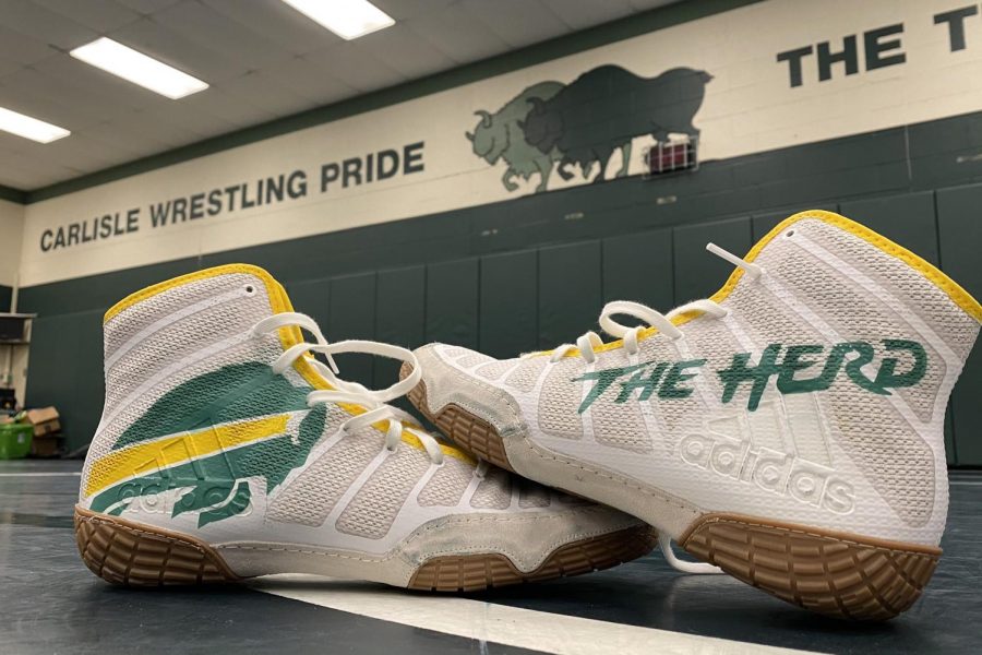 Carlisle+High+School+inspired+custom+wrestling+shoes+sit+in+the+middle+of+the+wrestling+room.+After+the+Thundering+Herds+long+practice+spent+preparing+for+the+2021+season.+The+Herd+look+to+improve+upon+their+8-7+season+a+year+ago.