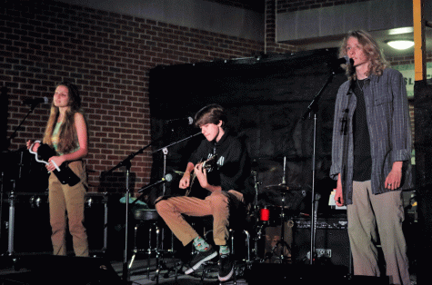 FLOORING AUDIENCES: Senior Renee Blacksmith and juniors Charlie Carlton and James Crawford take to the stage at the First Cup Coffeehouse performance night. Members of the band "Under the Floorboards," they performed "Somethin’ Stupid” by Frank and Nancy Sinatra. 