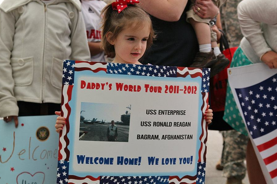 WELCOME HOME: The writer as a child waits in anticipation to see her dad, whos been deployed. Deployment can be a time of uncertainty but finally reuniting makes the wait worthwhile. 