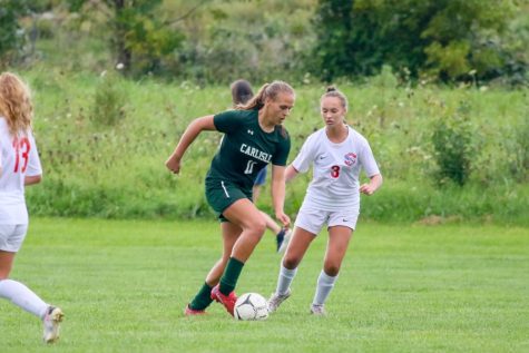 FULL STEAM AHEAD: Senior Sejla Podzic dribbles the ball down the field passing a Red Land defender. Podzic was the top scorer for the team with 15 goals at the end of regular season play.