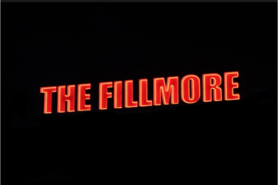 BRIGHT LIGHTS: The neon red sign of the Fillmore glows while a night of community forged in music comes together under its roof.