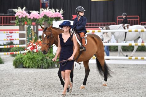 HORSING AROUND: Kelsey Lesh escorts her son, Russell Lesh, as he rides Cs King Triton. It was at the 2021 Pennsylvania National Horse Show where the mother and son duo participated in the classic leadline class. Lesh said it was special to get to exhibit there with my son and a pony that means so much to me.