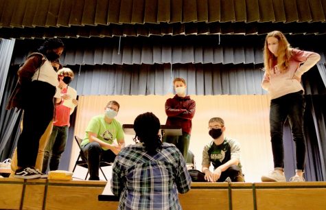 ALL EYES ON ME: Sophomore Sophie Akujobi (bottom center) gives directions to the cast of Titus Andronica (left to right: Sharon Kolubah, Lex Boyd, Aiden Wilt, Jacob Haney, Aedan Shevlin, Felonica Kirkham) during an afternoon rehearsal onstage in the Swartz Auditorium. “I cried at the end because it all went together so well,” Akujobi said, “and after the show I found each and every one of them and gave them a hug and told them how proud I was!”