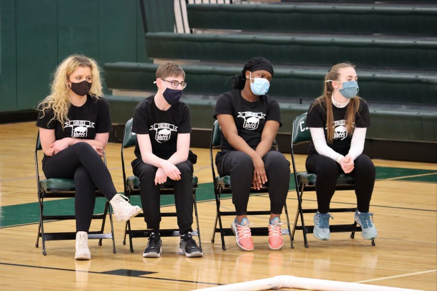 ANTICIPATION: Pictured from left to right are Tatum Kimmell, Sam Green, Crystal Jones, and Ellie Knapp sitting and watching their teammates from the other side of the court. Green said that he prefers the defensive side of the game, or knocking the other team’s balls away from the pallina. 