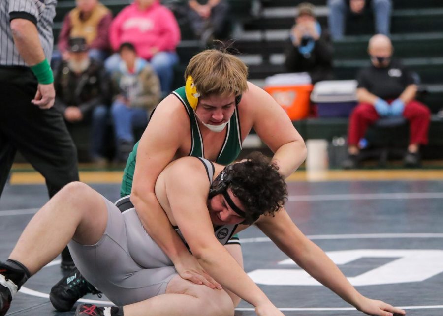 HEAVY PURSUIT: Layton Schmick (green singlet) pursues Mechanicsburgs Malakai Ayala in their bout in early January. Schmick would go on to record one of his 32 pins this season later on in this match. Beating the Carlisle record for most pins in a season (25) set by Ian Shannon in 2013.
