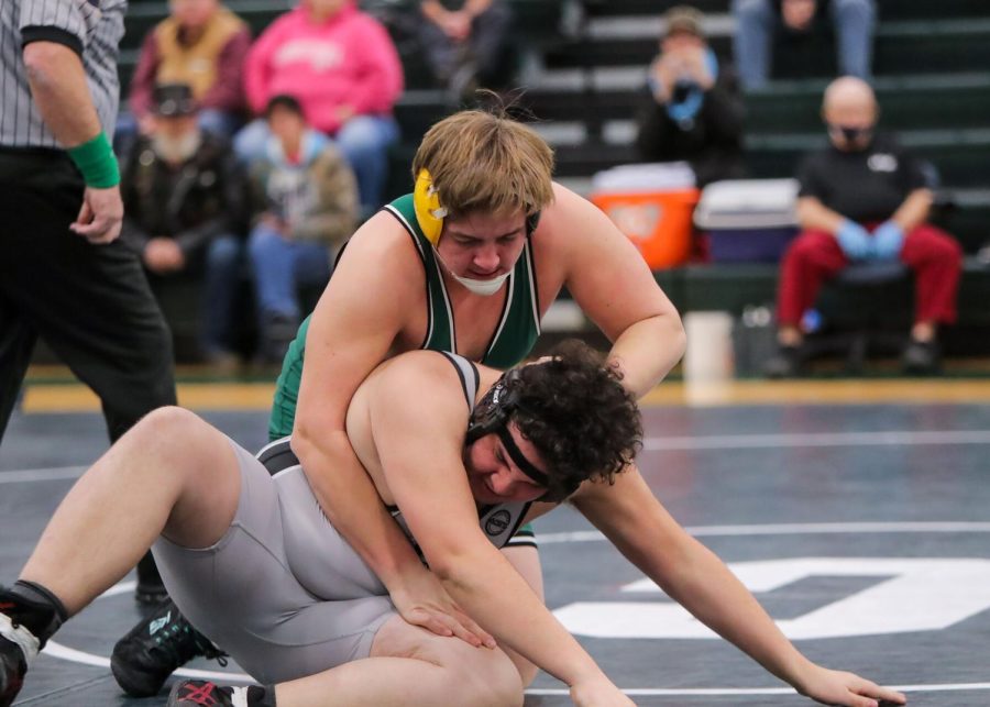 HEAVY PURSUIT: Layton Schmick (green singlet) pursues Mechanicsburg's Malakai Ayala in their bout in early January. Schmick would go on to record one of his 32 pins this season later on in this match. Beating the Carlisle record for most pins in a season (25) set by Ian Shannon in 2013.